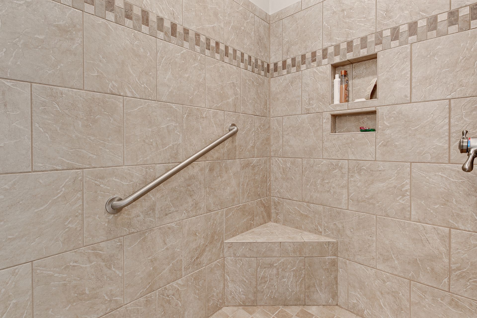 Senior-friendly walk-in shower with grab bar by ReelLine Building & Design in Montgomery County, PA