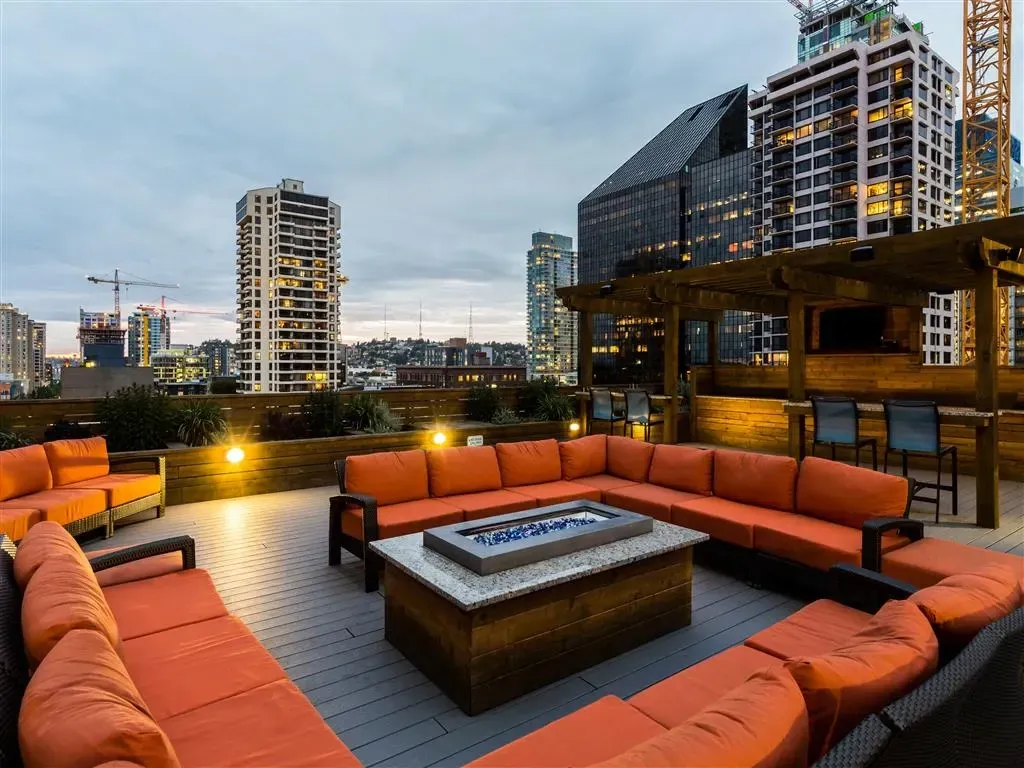 Rooftop lounge area with fire pit and city views