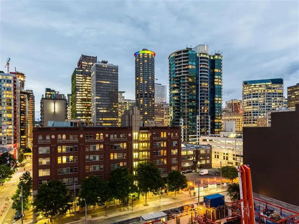 View of apartment buildings and city skyline at dusk
