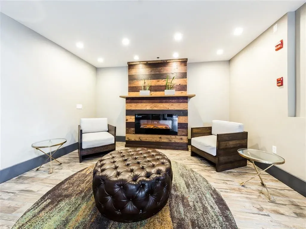 Modern lounge area with fireplace and seating.