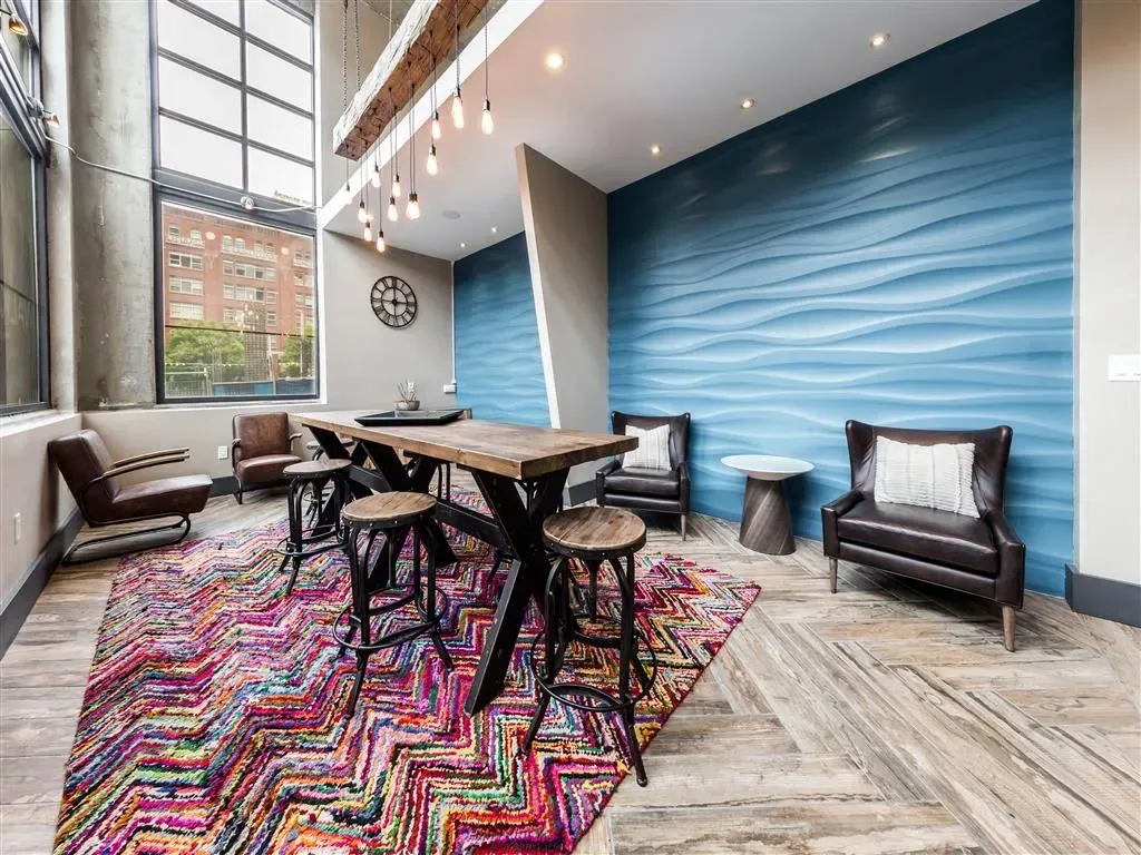Communal lounge area with textured blue wall and seating.