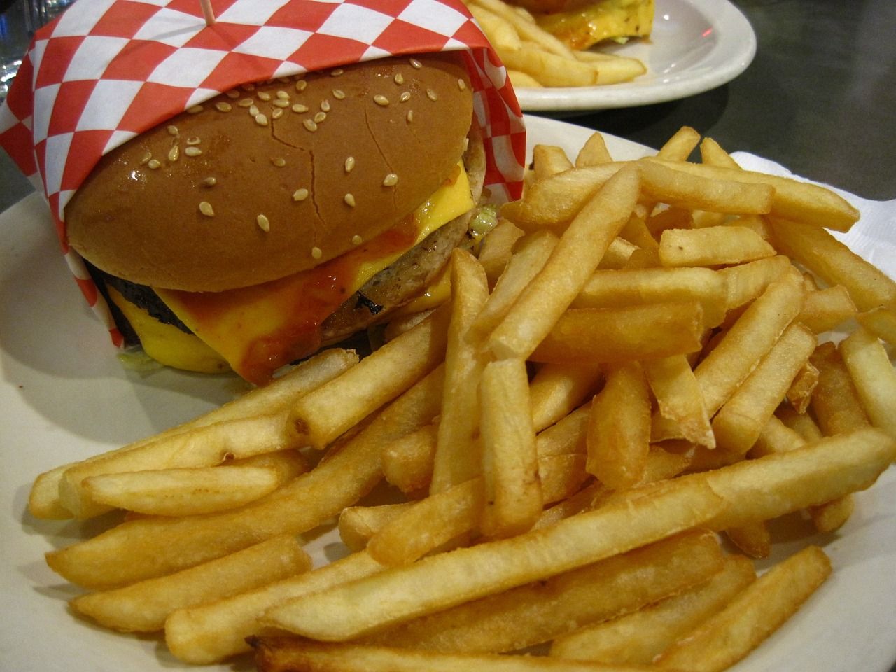 a hamburger and french fries on a white plate
