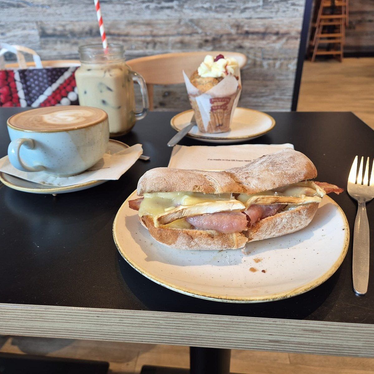 teacup with sandwiches pastries