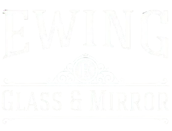 White storefront sign reading &ldquo;EWING&rdquo; and &ldquo;GLASS & MIRROR&rdquo; with a faint emblem in the center