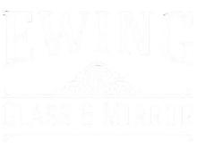 White storefront sign reading &ldquo;EWING&rdquo; and &ldquo;GLASS & MIRROR&rdquo; with a faint emblem in the center