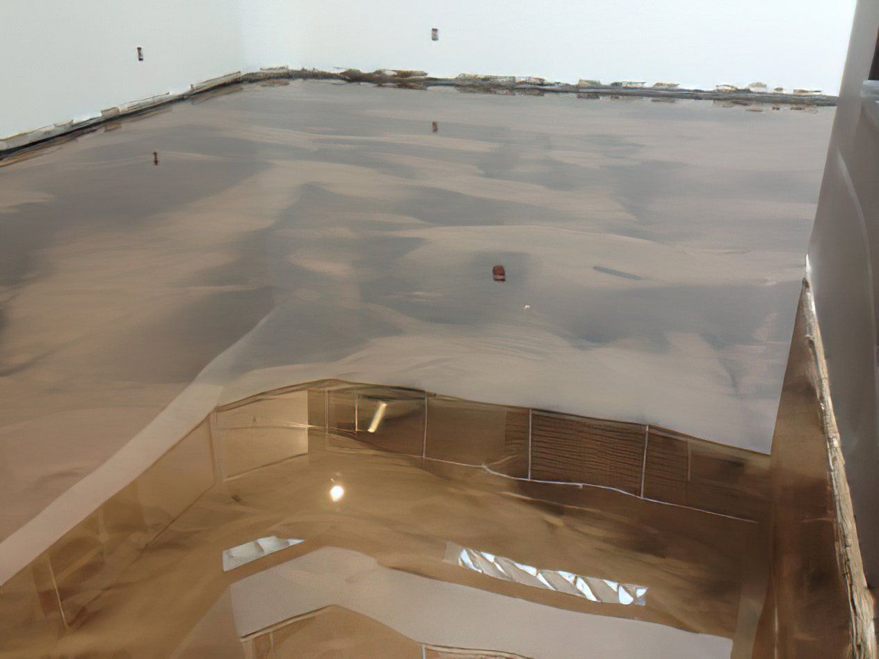 A room with a shiny floor and a white wall