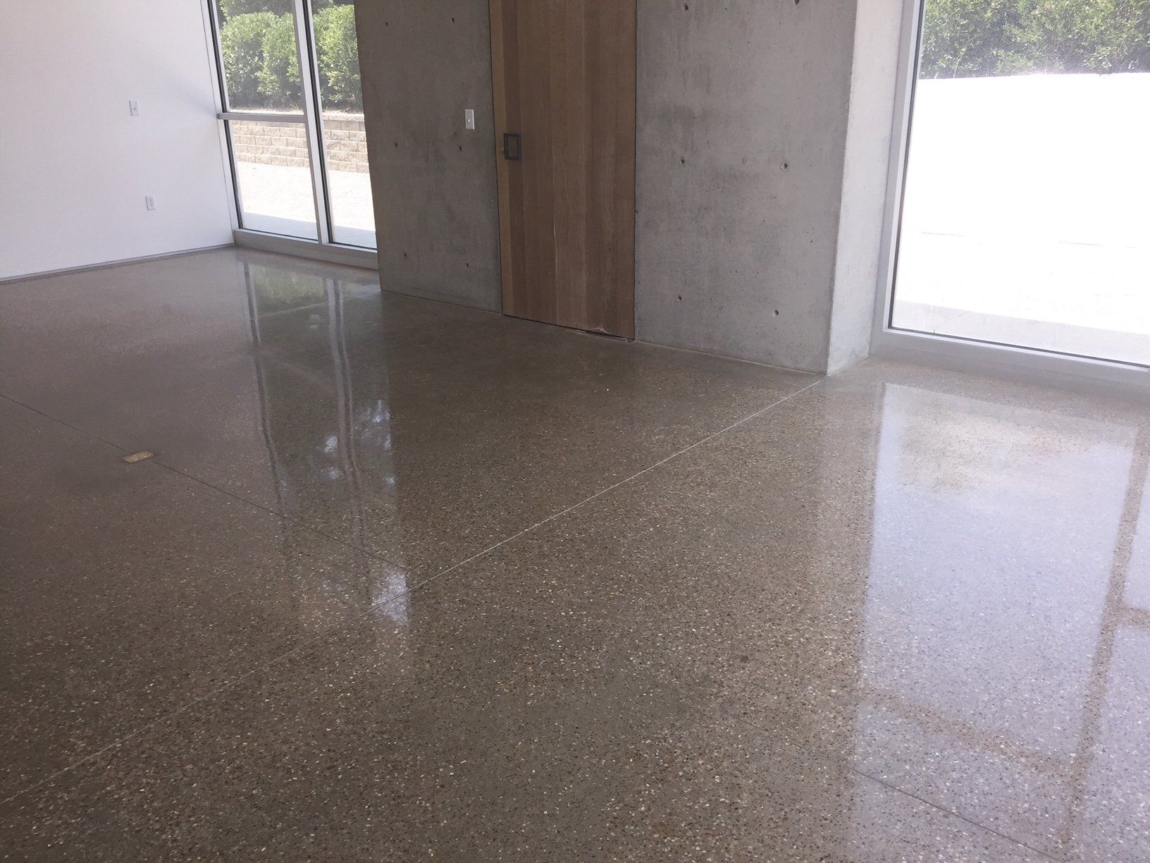 An empty room with a shiny floor and a door