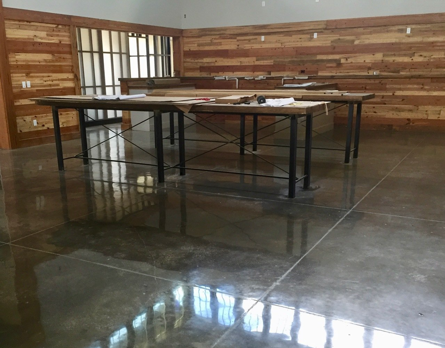 A room with two tables and a wooden wall