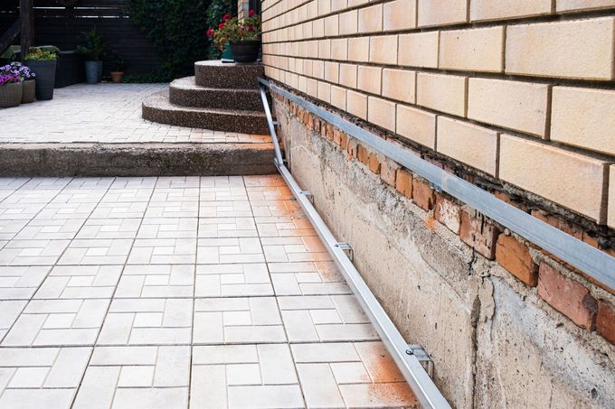 Low brick wall beside a paved walkway and steps outdoors