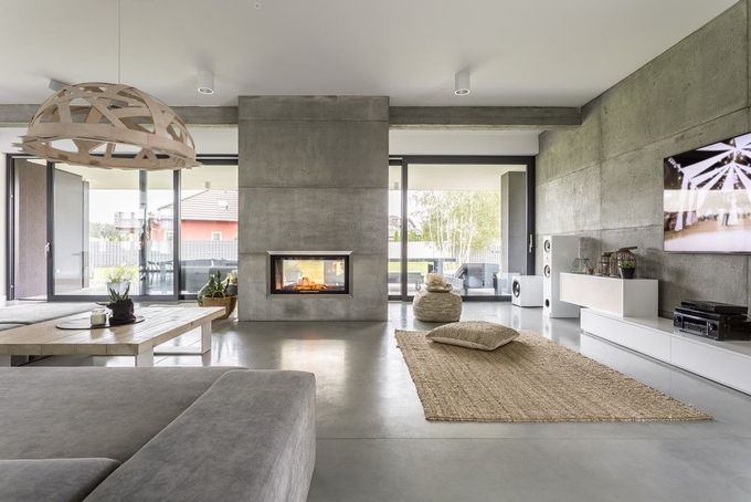 Modern minimalist living room with fireplace, large windows, white furniture, and a flat-screen TV