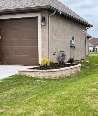Suburban home exterior with flower bed landscaping by Lonestar Customscapes