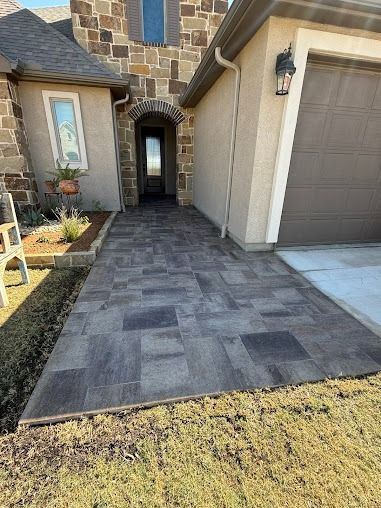 Stone walkway leading to front door with landscaped yard in Denton area
