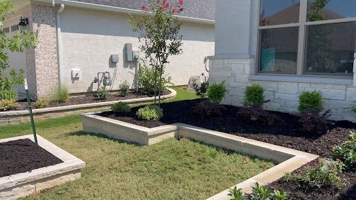 Landscaped courtyard with raised concrete planters and grass