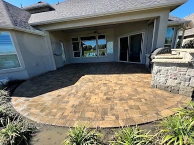 Brick paver patio with curved edge and covered outdoor seating area