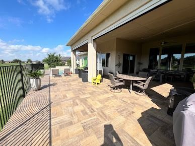 Covered patio with tile floor, outdoor dining, and fenced yard in Denton TX