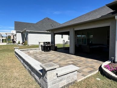 Stone seating wall beside covered outdoor living area in Denton TX