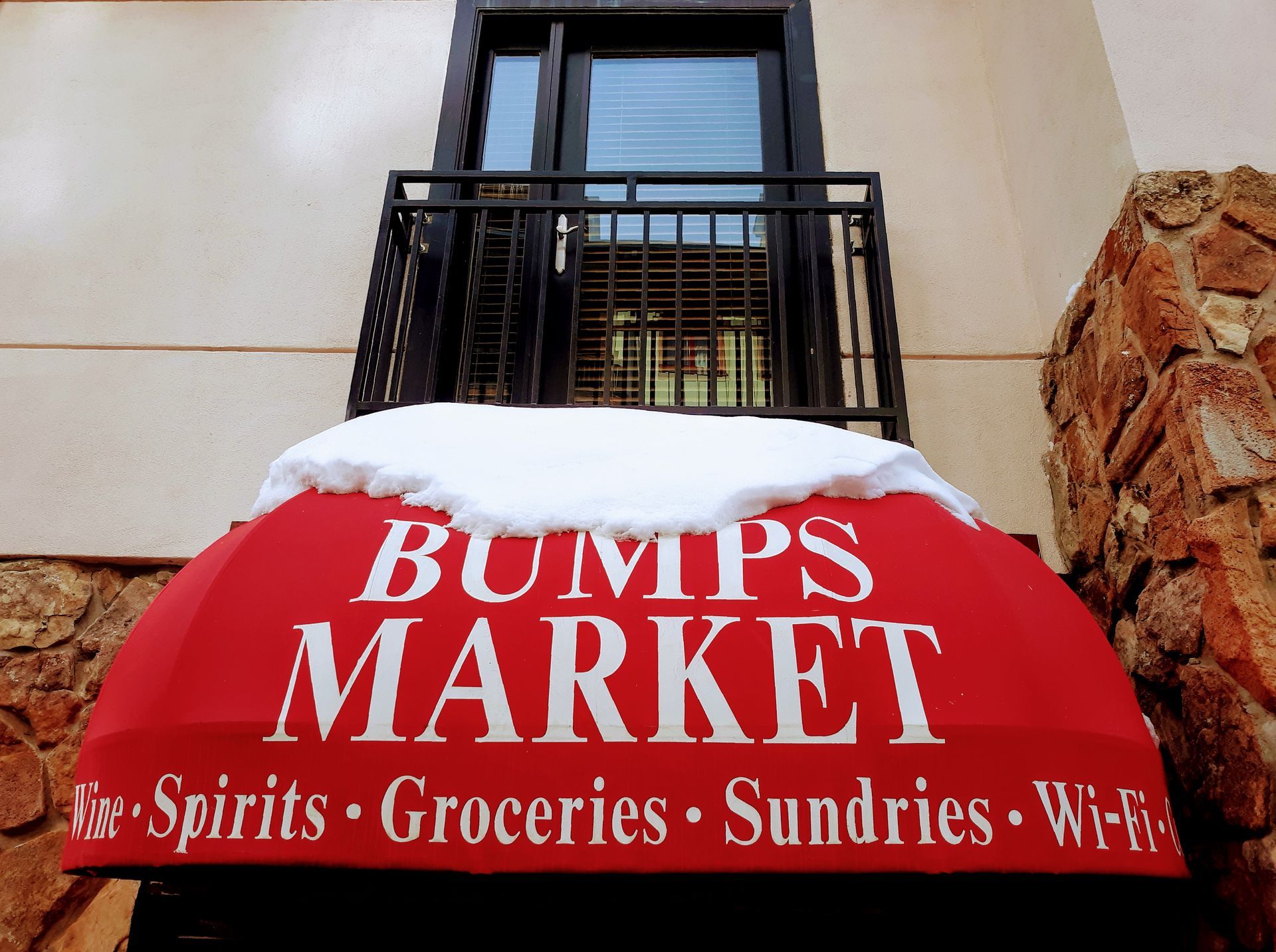 Bumps market has a red awning with snow on it