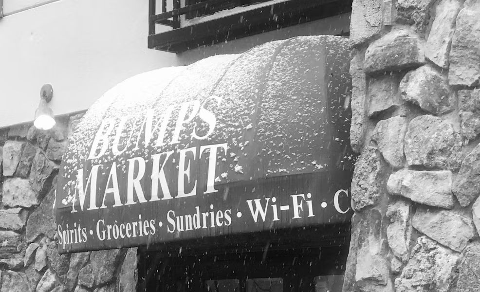 A black and white photo of a store called bumps market