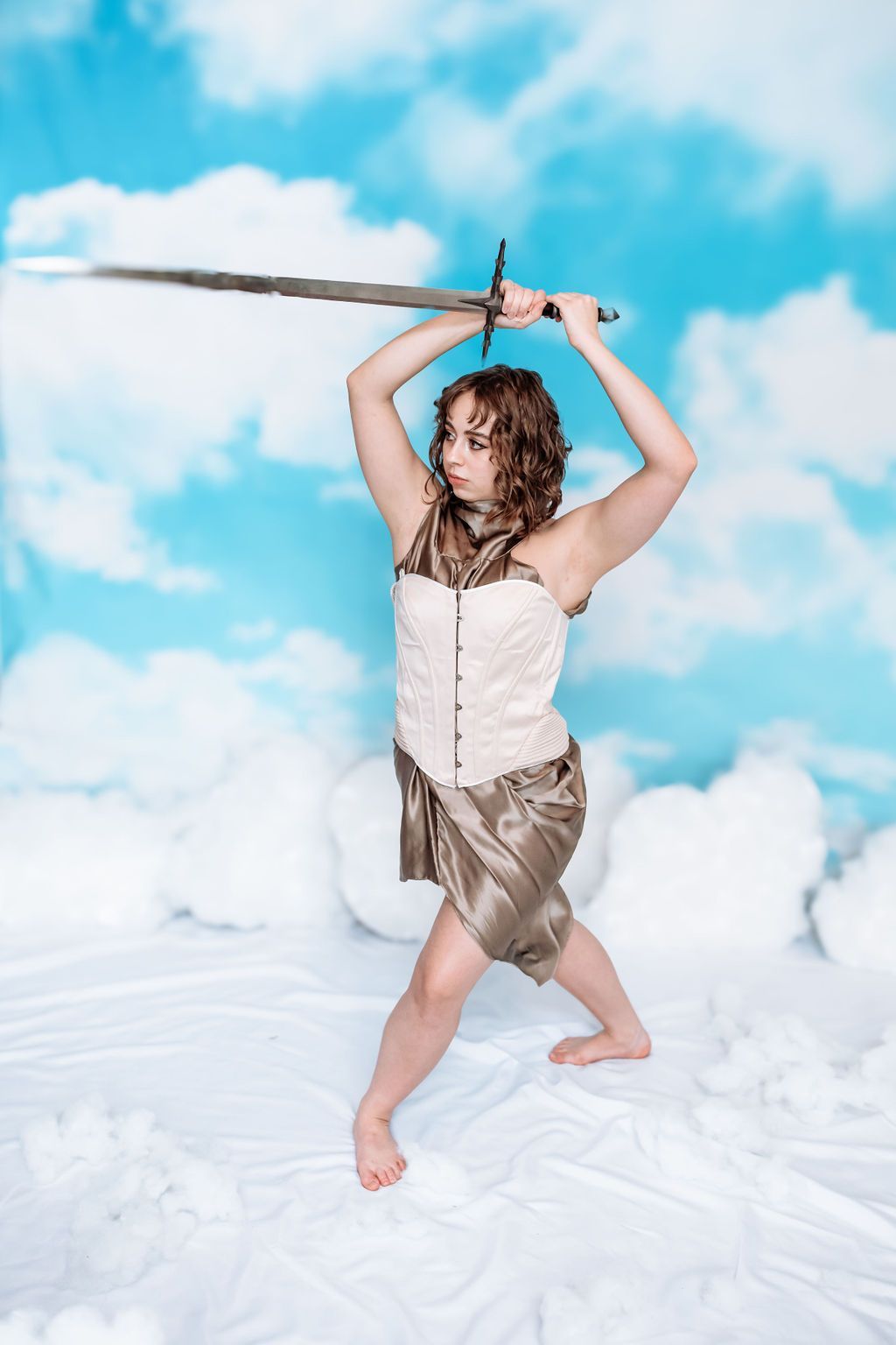 I woman in a corset holding a sword. 