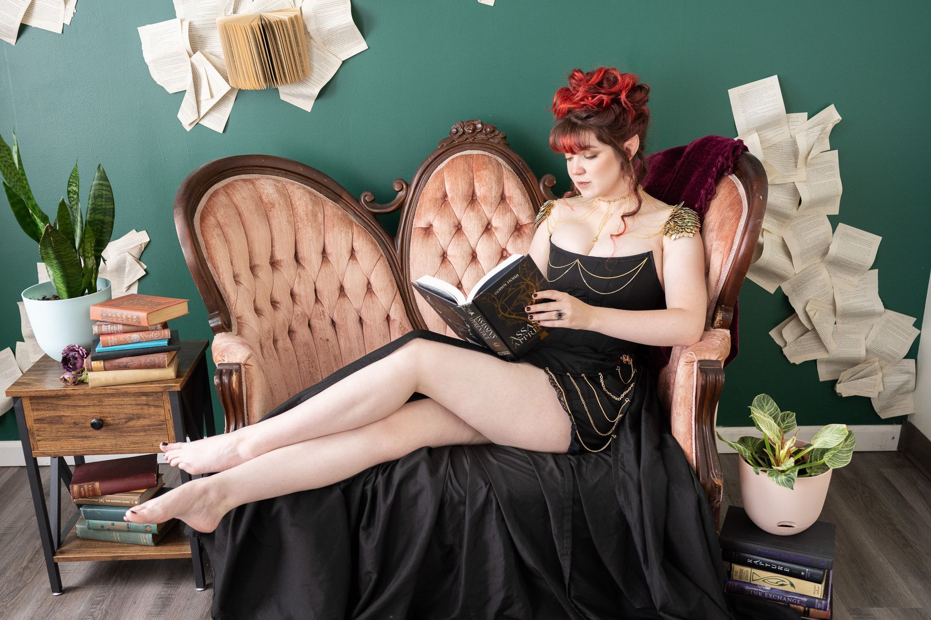 A woman is sitting on a couch reading a book.