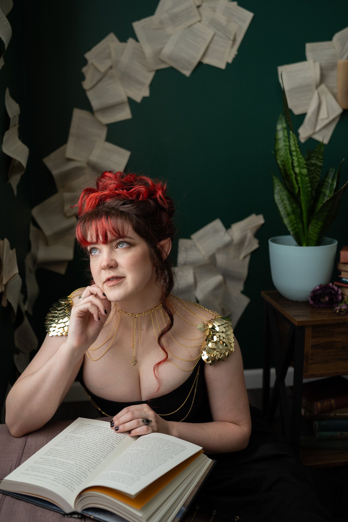 A woman is sitting at a table reading a book.