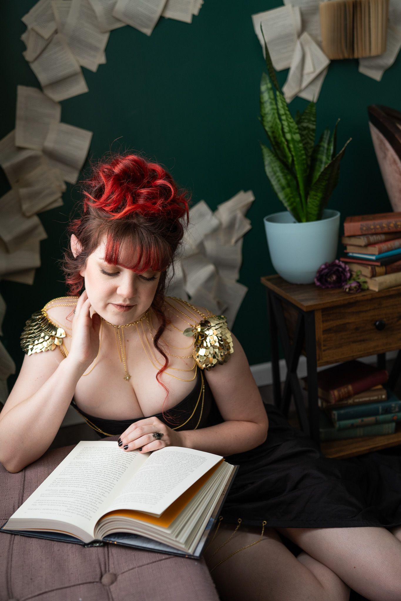 A woman is sitting on a couch reading a book.