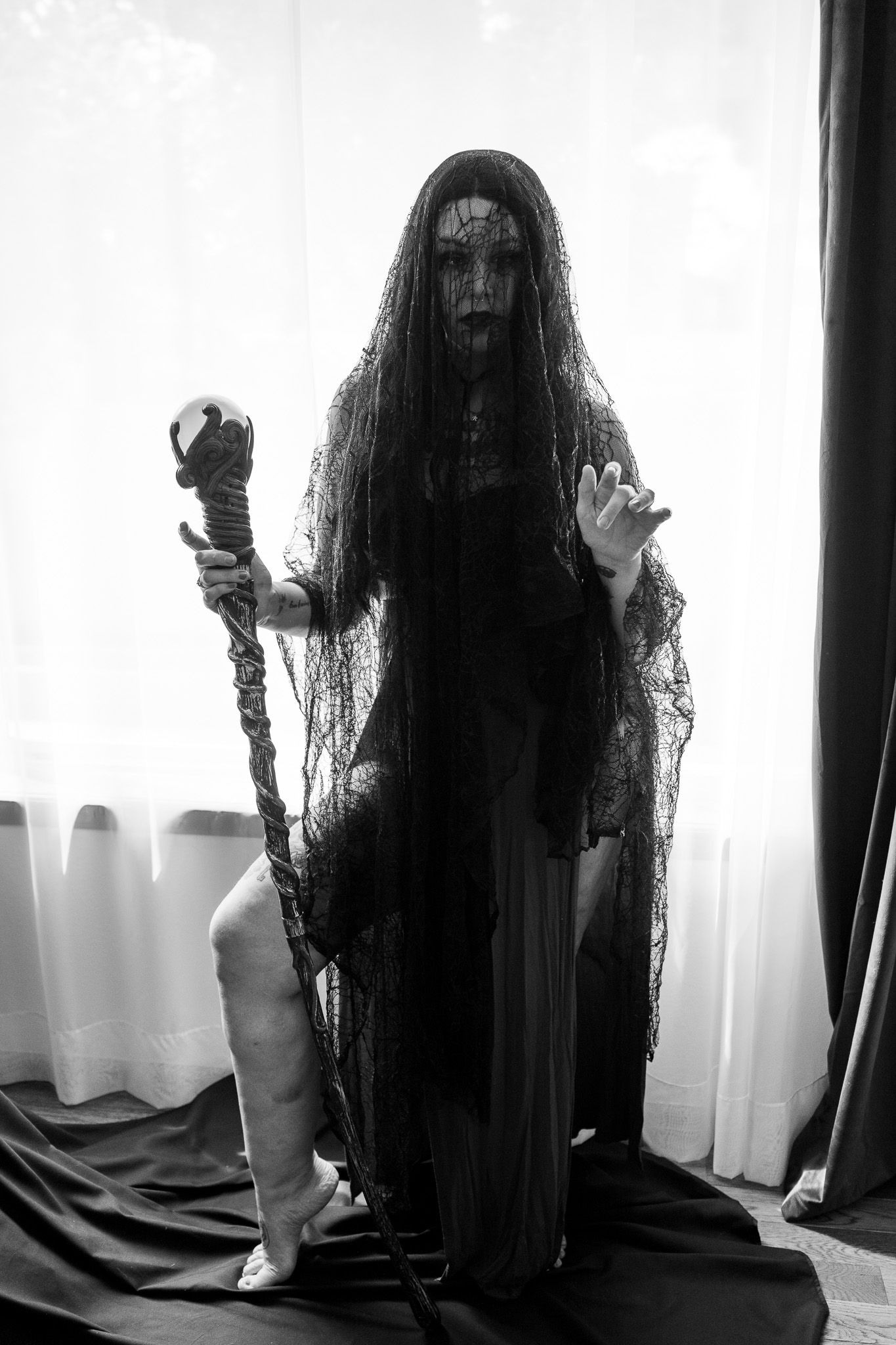 A black and white photo of a woman holding a cane