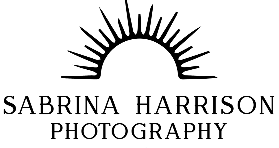 The logo for sabrina harrison photography is black and white and shows two trees.