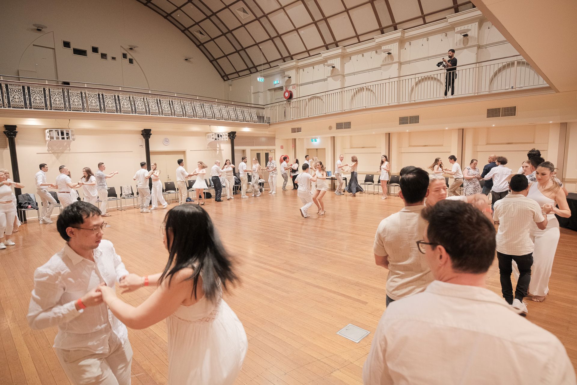 A group of people are dancing in a dance studio.