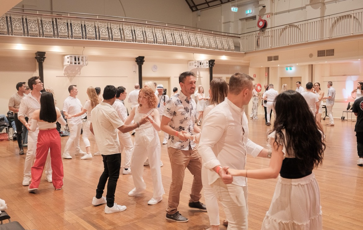 A man and a woman are dancing together in a room.