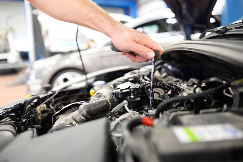 Car Mechanic In A Workshop Repairing A Vehicle — Autocool Air Conditioning in Tea Gardens, NSW