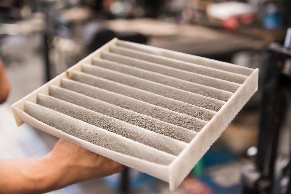 Mechanic Holding Used Dirty On Air Filter Car While Service At Garage — Autocool Air Conditioning in Maitland, NSW