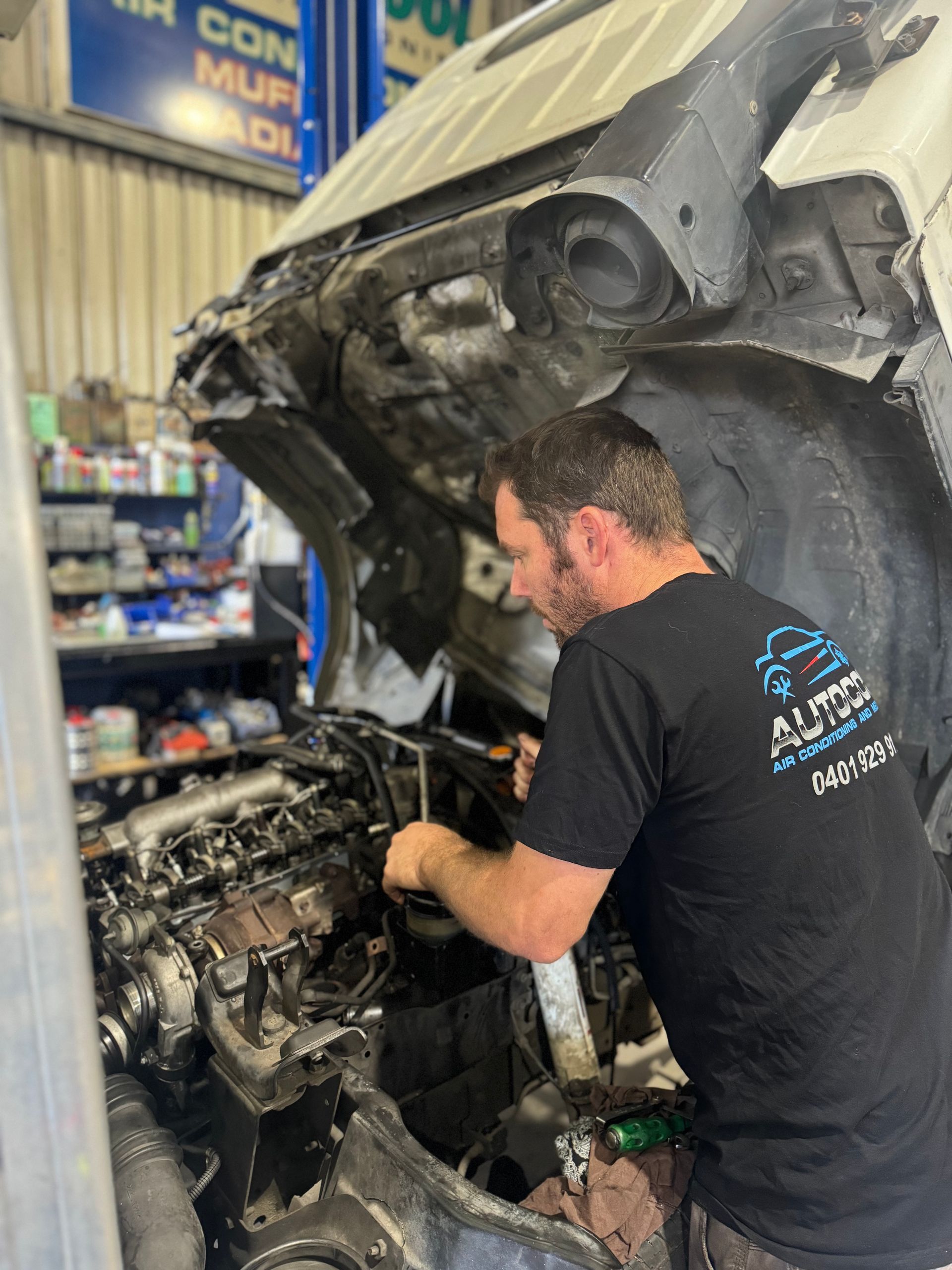 A Mechanic Is Working The Air Conditioning Of The Car — Autocool Air Conditioning in Raymond Terrace, NSW