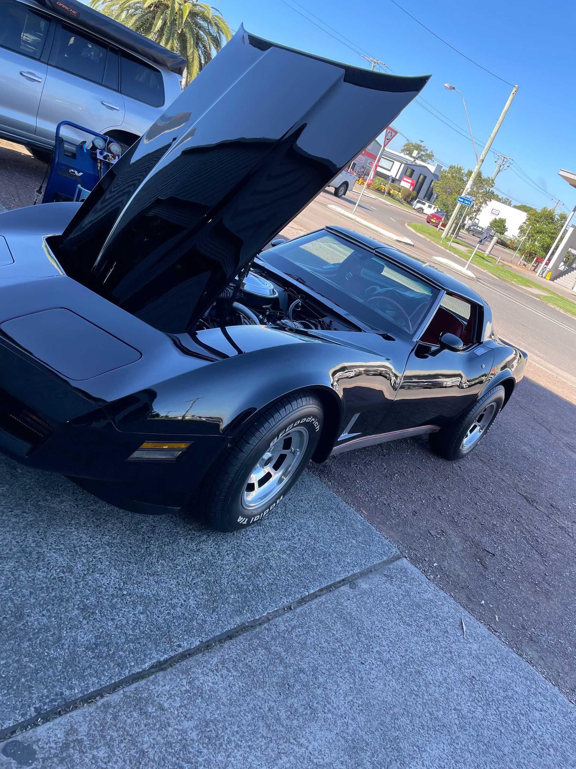 A Black Corvette With The Hood Up Is Parked On The Side Of The Road — Autocool Air Conditioning in Raymond Terrace, NSW