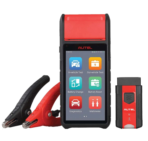 A red and black autel device is sitting next to a pair of clamps.