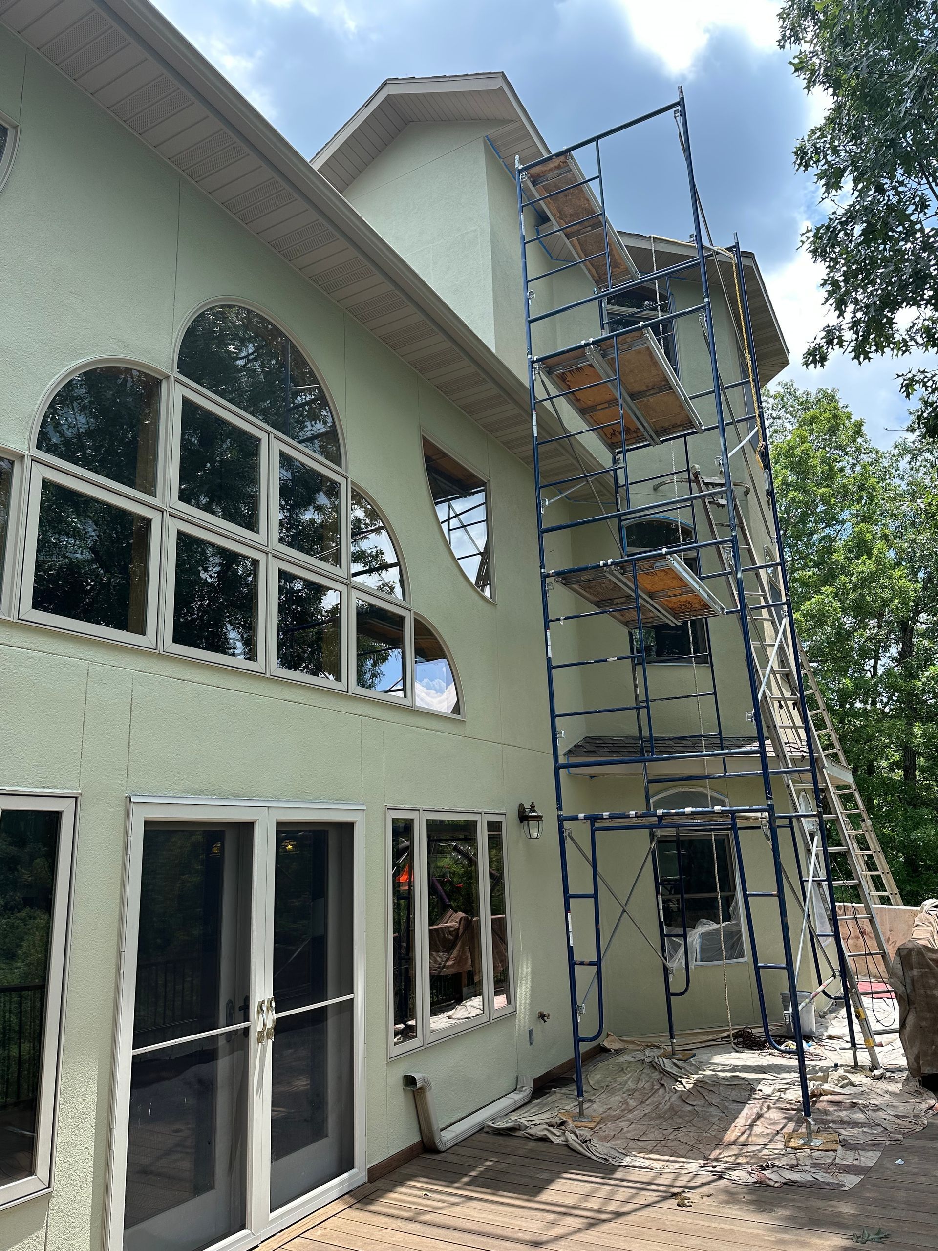 House exterior with scaffolding and ladders during construction or maintenance