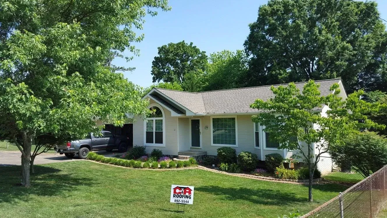 House with light siding and gray roof