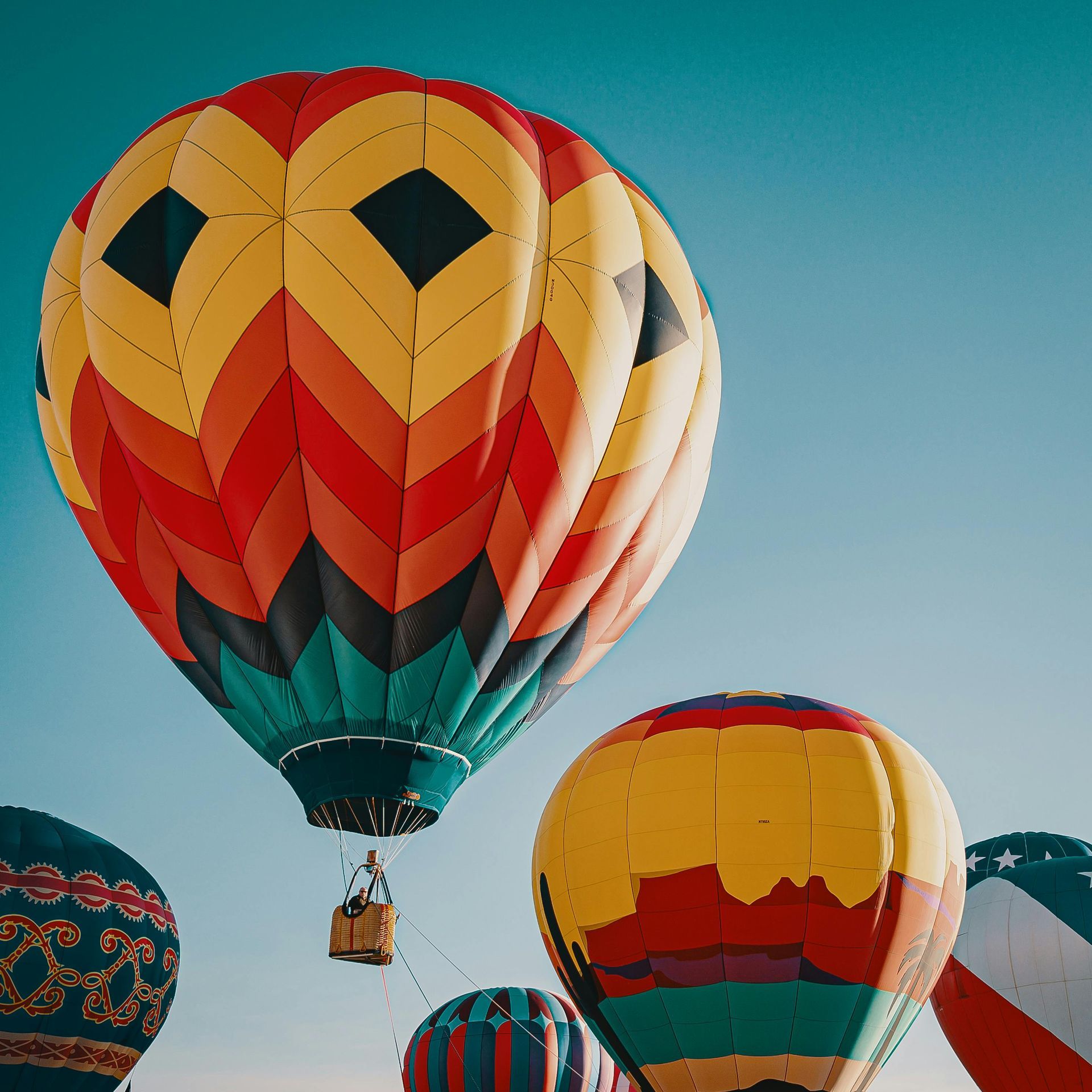 A bunch of hot air balloons are flying in the sky