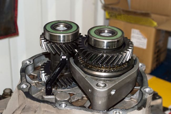 Close-up of metal gears and bearings inside a mechanical transmission assembly.