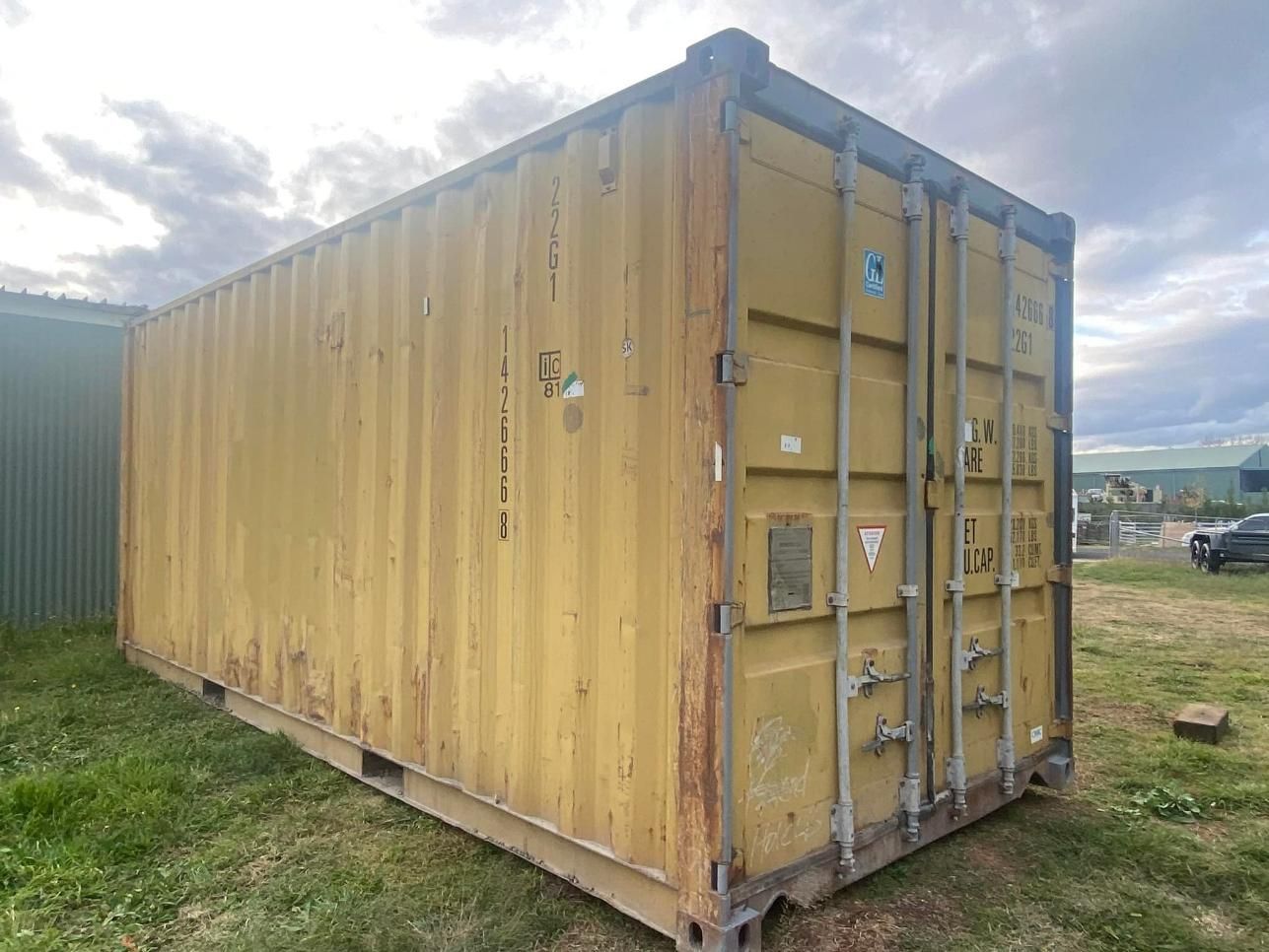 A Weathered, Yellow Shipping Container — New England Towing in Inverell, NSW