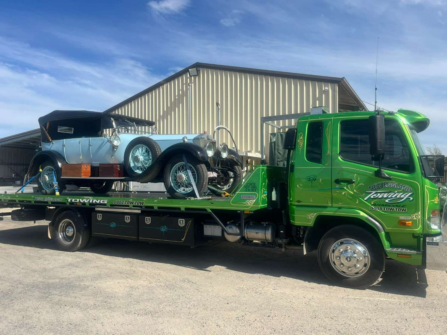 A Light Blue Vintage Car Being Transported on A Bright Green Tow Truck — New England Towing in Inverell, NSW