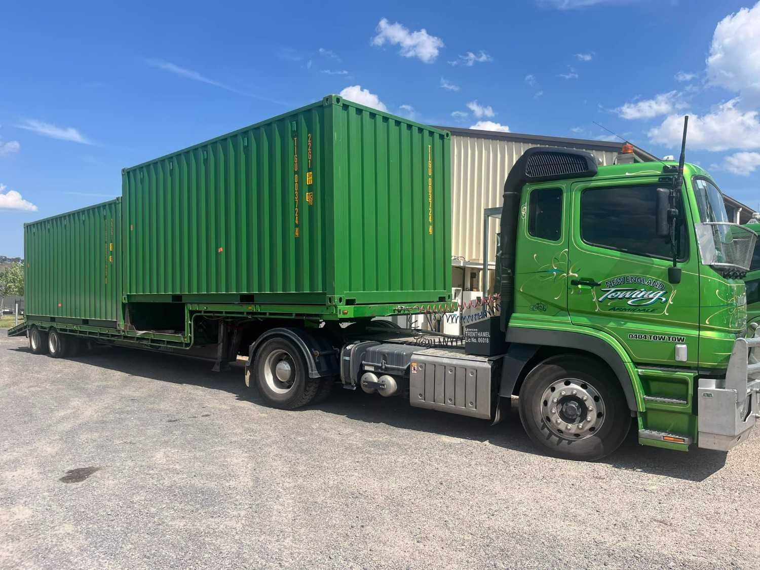 Green Semi-Truck Hauling Two Green Shipping Containers Under the Blue Sky— New England Towing in Ebor, NSW