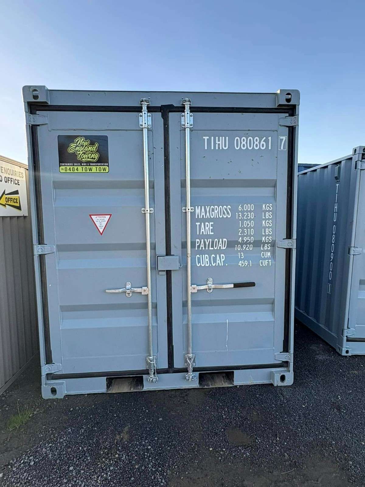 A Gray Shipping Container with Closed Doors and Metal Latches — New England Towing in Guyra, NSW
