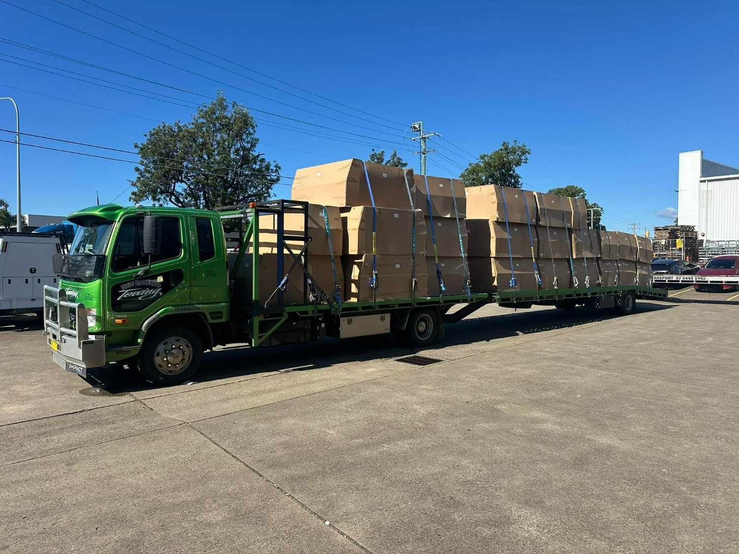 Green Truck Loaded with Cardboard Boxes — New England Towing in Walcha, NSW