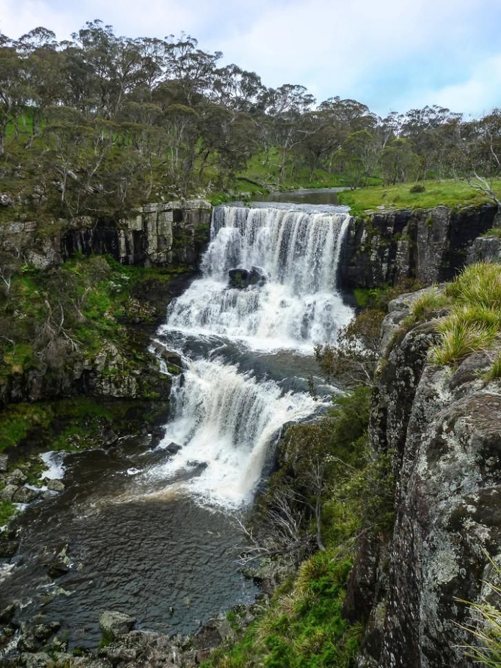 Waterfall Cascading Over Layered Rock Into a Dark Pool Below — New England Towing in Ebor, NSW