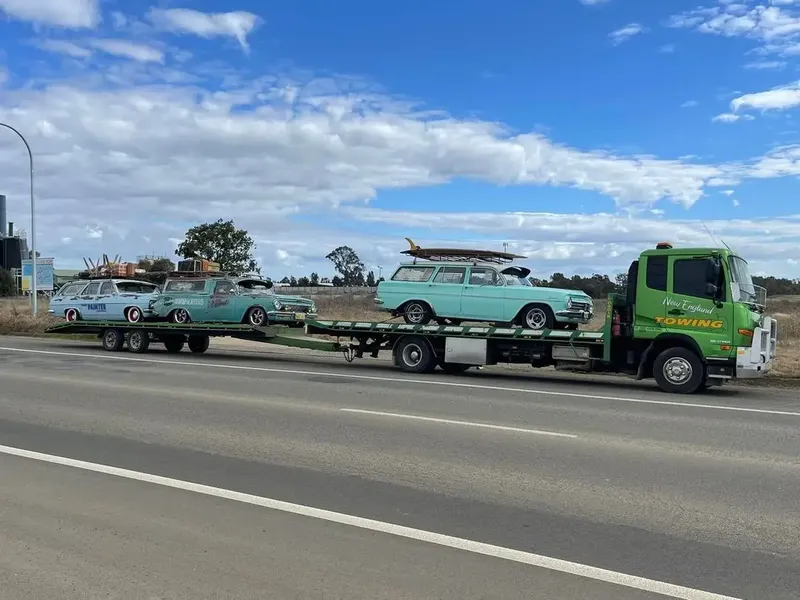 Shipping Container Trucks Along Highway — New England Towing in Glen Innes, NSW