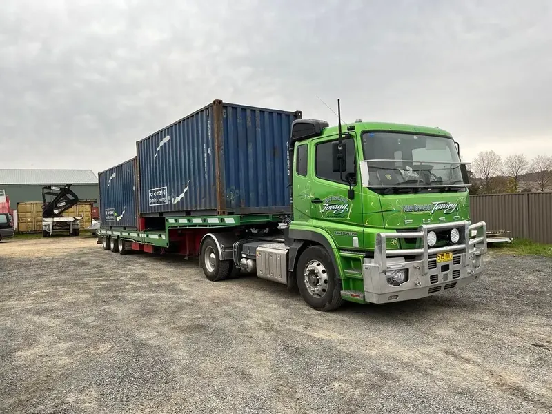 Shipping Container Trucks Along Highway — New England Towing in Armidale, NSW