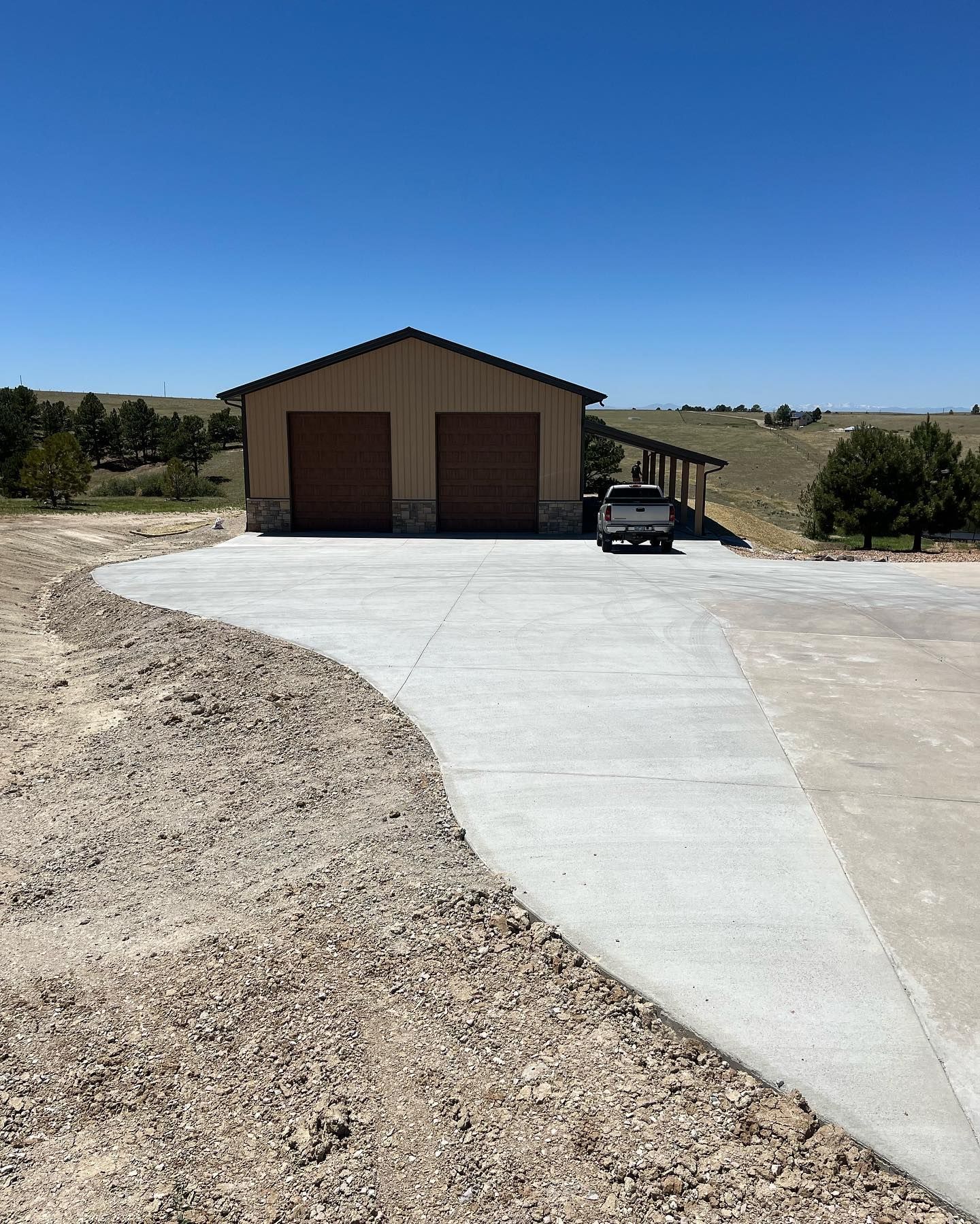 A car is parked in a driveway in front of a garage.