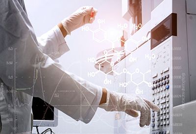 A scientist is working on a machine in a laboratory.