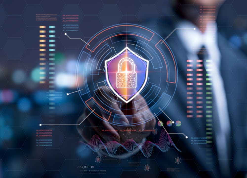 A man in a suit is holding a shield with a padlock on it.